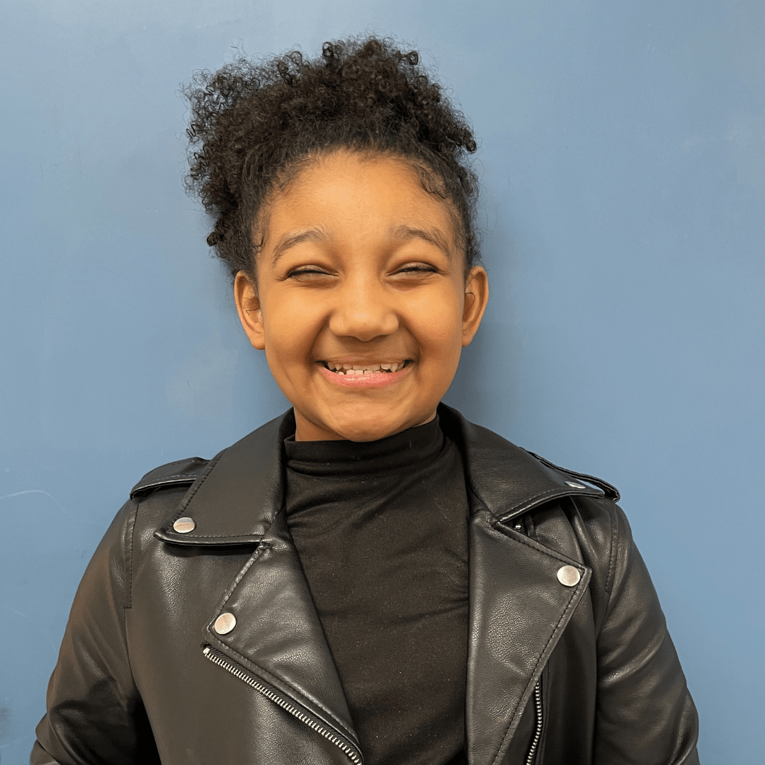 Dalilah, a fourth grade girl, smiles at the camera